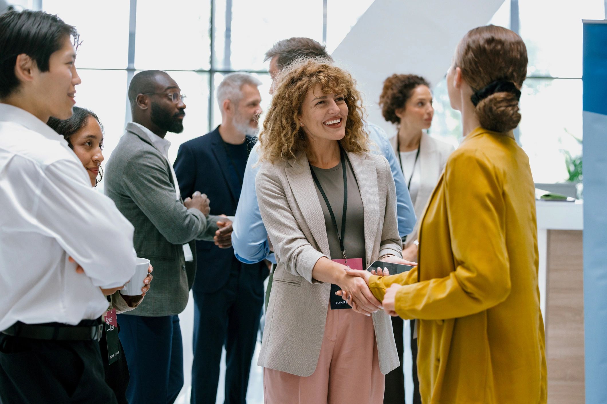 Businesswomen greeting each other outside a conference hall